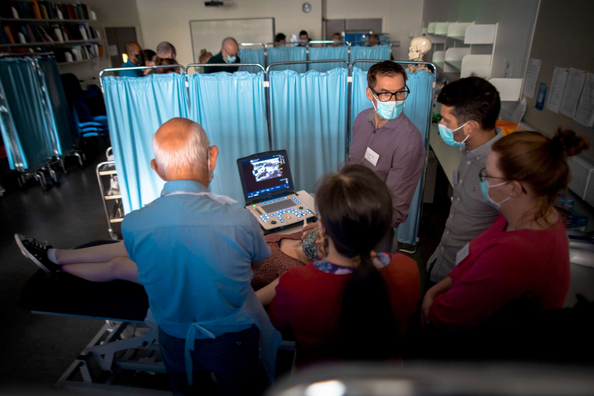 A group of people using Ultrasound machines. 
