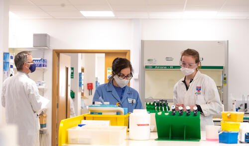 Students wearing face-coverings during labwork, University of St students in lab